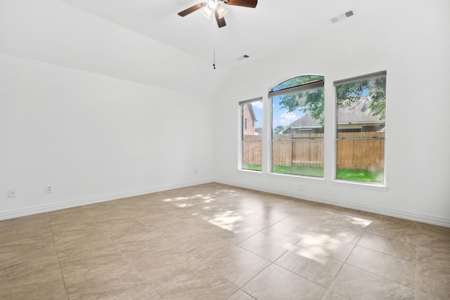 10323 Otter Cir, Baytown, TX 77523 - empty room with a ceiling fan, lofted ceiling, baseboards, and light tile patterned floors