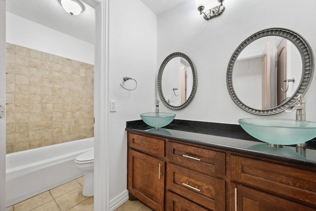 10323 Otter Cir, Baytown, TX 77523 - full bath with double vanity, tile patterned floors, toilet, and shower / bath combination