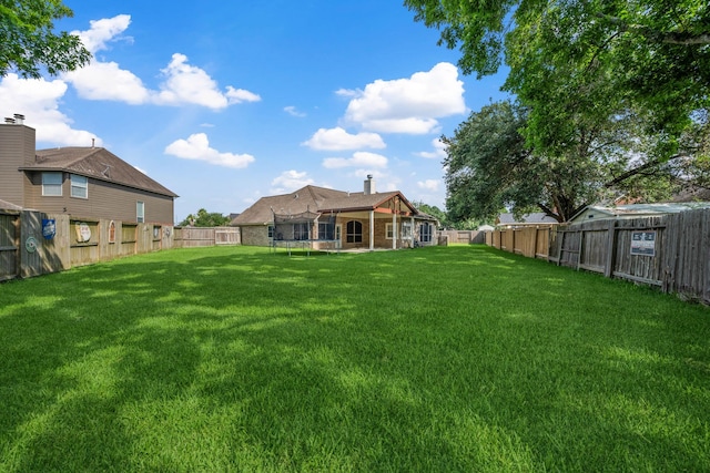 10323 Otter Cir, Baytown, TX 77523 - view of yard with a trampoline