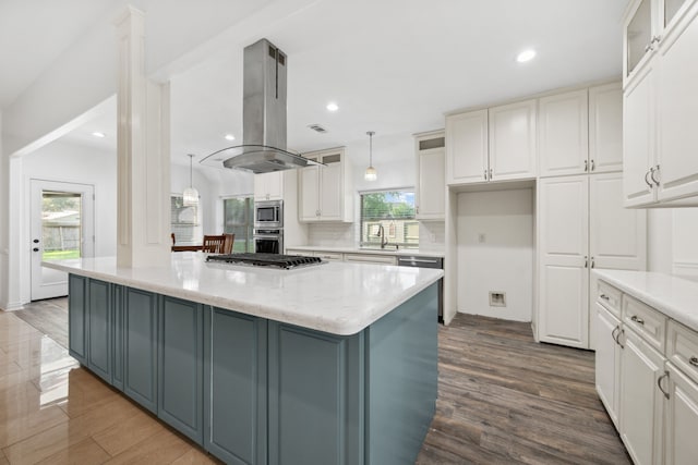 10323 Otter Cir, Baytown, TX 77523 - kitchen featuring island range hood, stainless steel appliances, a sink, white cabinets, and dark wood finished floors