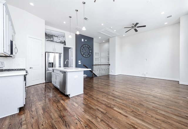 24 N N Hutcheson St, Houston, TX 77003 - kitchen featuring appliances with stainless steel finishes, open floor plan, a ceiling fan, dark wood-style flooring, and recessed lighting