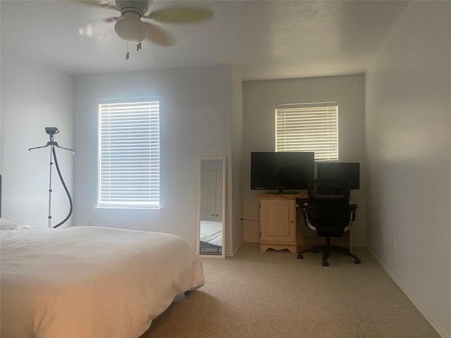 19042 Yaupon Ranch Dr, Cypress, TX 77433 - bedroom with light carpet, baseboards, a ceiling fan, and a desk