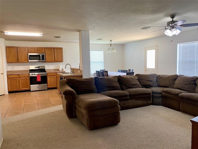 19042 Yaupon Ranch Dr, Cypress, TX 77433 - living area featuring light tile patterned flooring, light carpet, and a ceiling fan