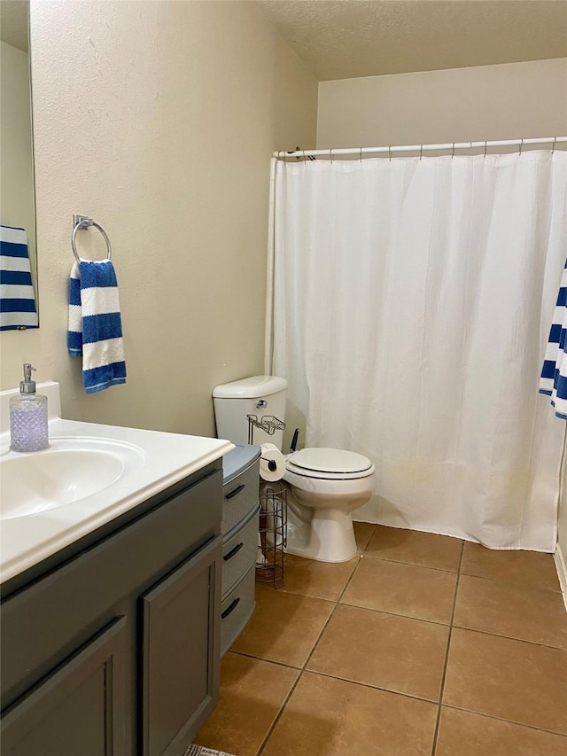 19042 Yaupon Ranch Dr, Cypress, TX 77433 - bathroom featuring vanity, tile patterned flooring, a shower with curtain, and a textured ceiling