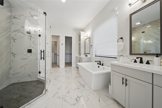 18011 Brazos River Cir, Cypress, TX 77433 - full bathroom featuring a marble finish shower, a walk in closet, vanity, a freestanding bath, and marble finish flooring