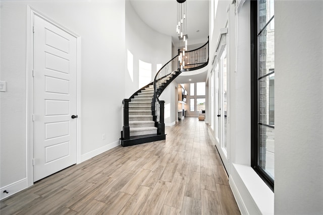 18011 Brazos River Cir, Cypress, TX 77433 - entrance foyer with stairway, wood finished floors, baseboards, and a towering ceiling