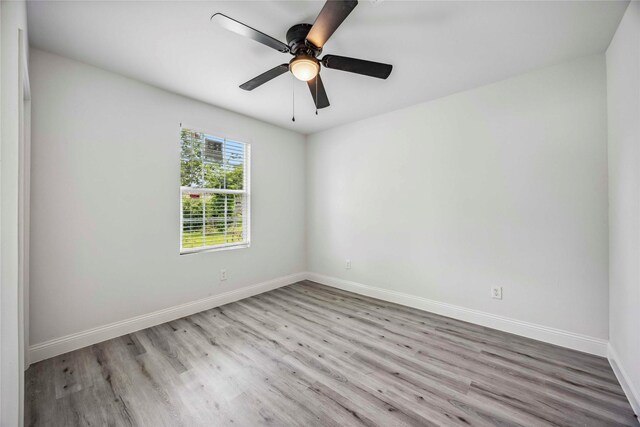 5751 Belmark St, Houston, TX 77033 - unfurnished room featuring wood finished floors, baseboards, and a ceiling fan