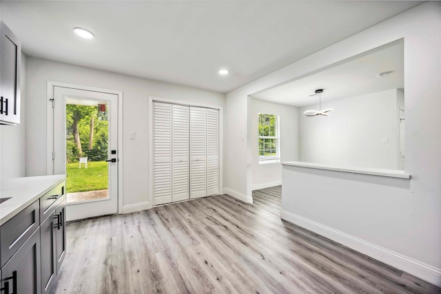 5751 Belmark St, Houston, TX 77033 - unfurnished dining area with light wood-style floors, baseboards, and recessed lighting