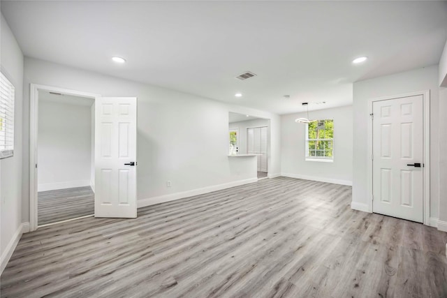 5751 Belmark St, Houston, TX 77033 - unfurnished living room featuring wood finished floors, baseboards, and recessed lighting