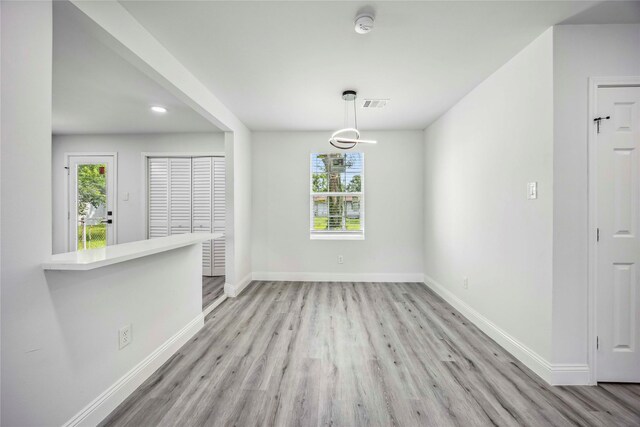 5751 Belmark St, Houston, TX 77033 - unfurnished dining area with wood finished floors, baseboards, and recessed lighting