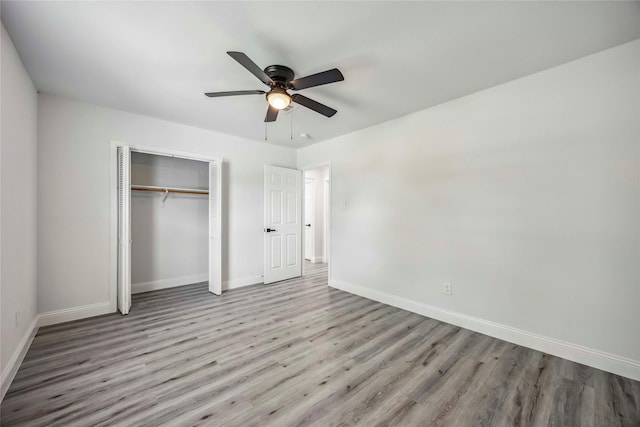5751 Belmark St, Houston, TX 77033 - unfurnished bedroom featuring baseboards, wood finished floors, a closet, and a ceiling fan