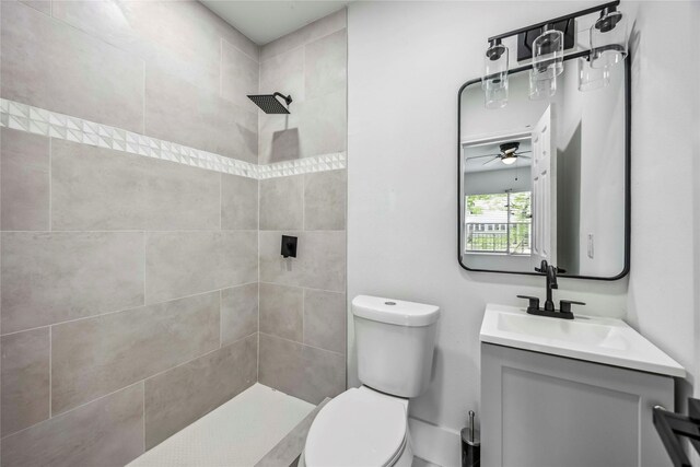 5751 Belmark St, Houston, TX 77033 - full bath with a tile shower, toilet, vanity, and ceiling fan
