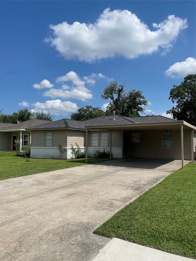 8630 Flossie Mae St, Houston, TX 77029 - ranch-style house with concrete driveway, a front yard, and an attached carport