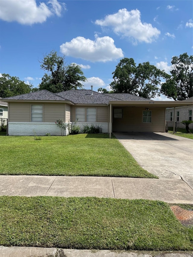 8630 Flossie Mae St, Houston, TX 77029 - ranch-style home featuring driveway, brick siding, a front yard, an attached carport, and a shingled roof