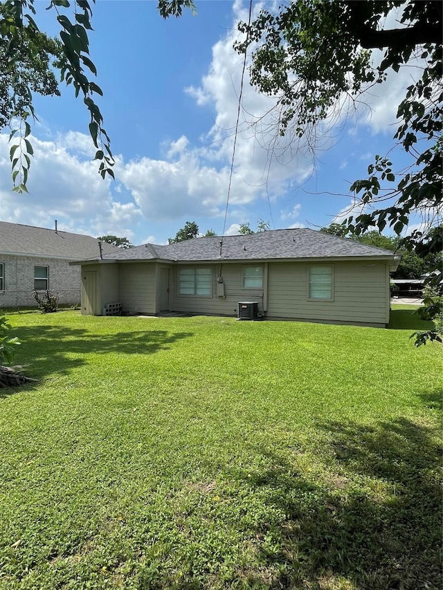 8630 Flossie Mae St, Houston, TX 77029 - back of house with a lawn and cooling unit
