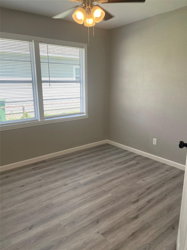 8630 Flossie Mae St, Houston, TX 77029 - unfurnished room featuring ceiling fan, baseboards, plenty of natural light, and wood finished floors