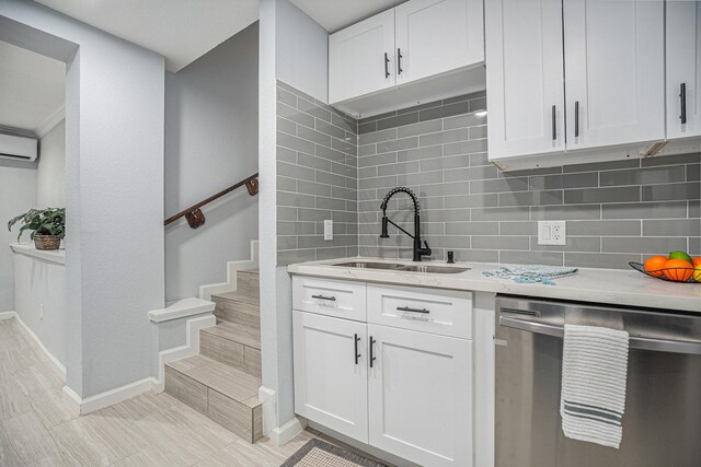 7449 Walker St, Houston, TX 77011 - kitchen featuring dishwasher, a sink, light countertops, an AC wall unit, and decorative backsplash