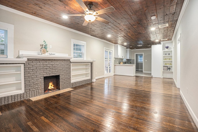 7449 Walker St, Houston, TX 77011 - unfurnished living room with ornamental molding, hardwood / wood-style floors, built in features, ceiling fan, and wood ceiling
