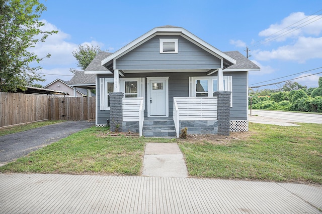 7449 Walker St, Houston, TX 77011 - bungalow featuring roof with shingles, a porch, and driveway
