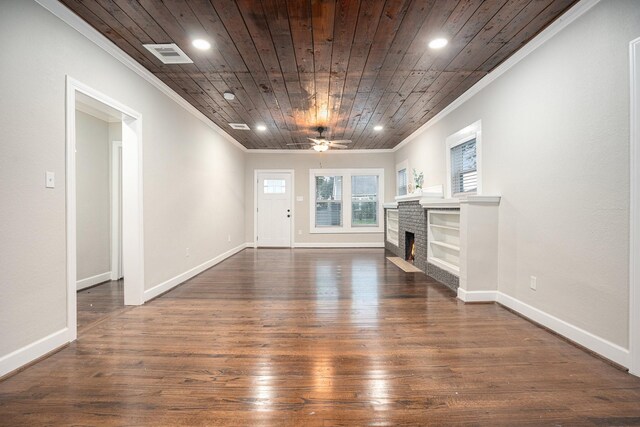 7449 Walker St, Houston, TX 77011 - unfurnished living room with ornamental molding, wooden ceiling, dark wood finished floors, a brick fireplace, and ceiling fan