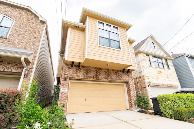 1306 Malone St, Houston, TX 77007 - view of property featuring an attached garage, brick siding, and concrete driveway
