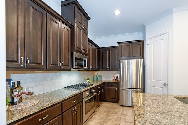 1306 Malone St, Houston, TX 77007 - kitchen with stainless steel appliances, light stone countertops, dark brown cabinets, crown molding, and backsplash