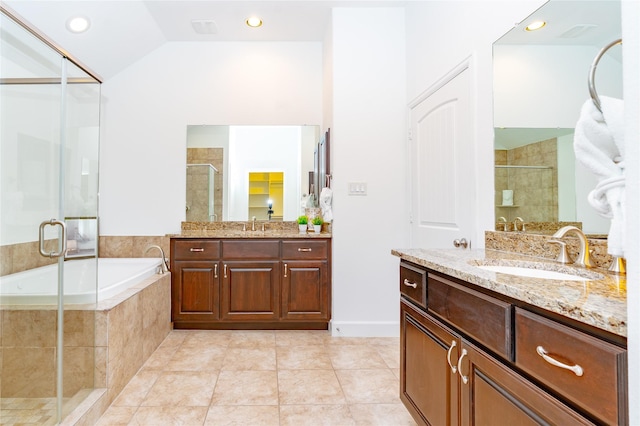 1306 Malone St, Houston, TX 77007 - full bathroom with two vanities, a shower stall, a garden tub, lofted ceiling, and tile patterned floors