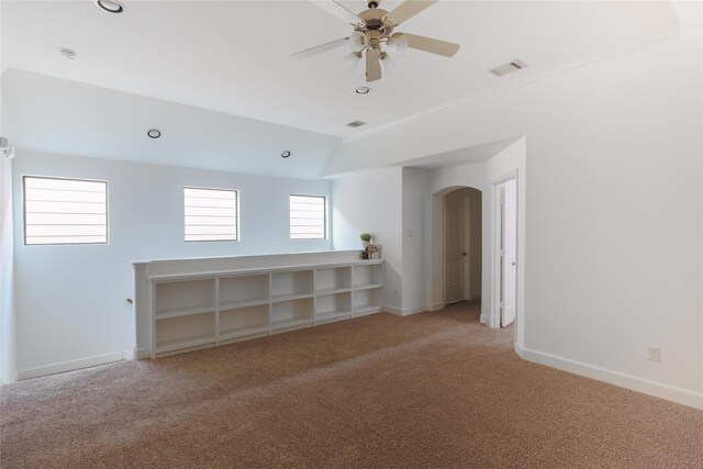 1306 Malone St, Houston, TX 77007 - empty room with carpet flooring, arched walkways, baseboards, ceiling fan, and vaulted ceiling