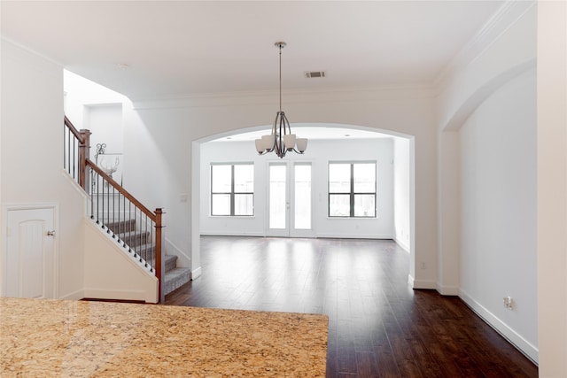 1306 Malone St, Houston, TX 77007 - unfurnished living room featuring a chandelier, dark wood finished floors, stairway, ornamental molding, and arched walkways