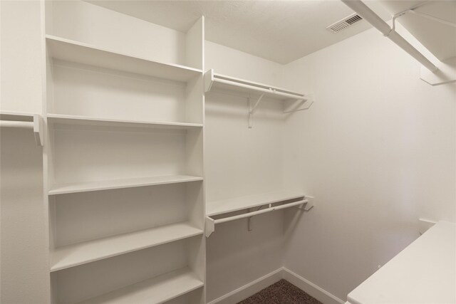 1306 Malone St, Houston, TX 77007 - spacious closet featuring dark colored carpet