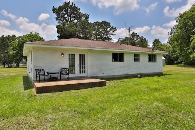 1137 Jones Rd, New Waverly, TX 77358 - rear view of house featuring french doors, a lawn, brick siding, and roof with shingles