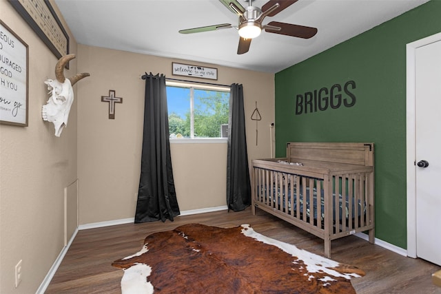 1137 Jones Rd, New Waverly, TX 77358 - bedroom featuring wood finished floors, baseboards, and a nursery area