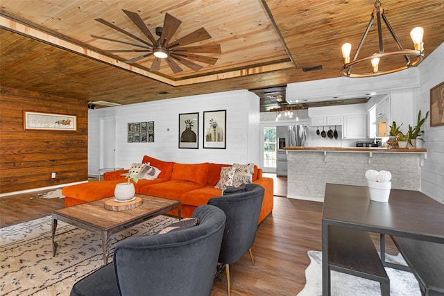 1137 Jones Rd, New Waverly, TX 77358 - living area with wooden ceiling, wood finished floors, wood walls, a ceiling fan, and a chandelier