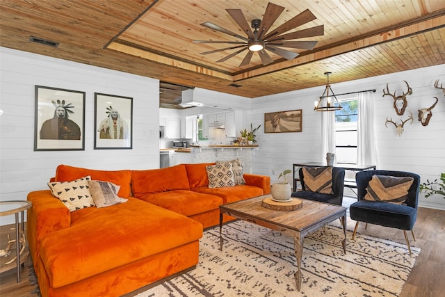 1137 Jones Rd, New Waverly, TX 77358 - living area with wooden ceiling, wooden walls, wood finished floors, and a ceiling fan