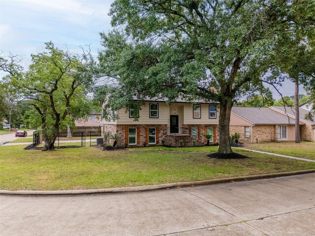 8707 Wind Side Dr, Houston, TX 77040 - bi-level home featuring brick siding