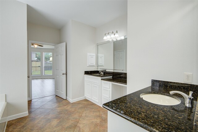 26122 Salt Creek Ln, Katy, TX 77494 - bathroom with two vanities, baseboards, and a chandelier