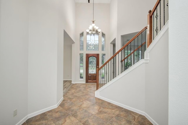 26122 Salt Creek Ln, Katy, TX 77494 - foyer with a chandelier, a towering ceiling, stairs, baseboards, and stone finish flooring