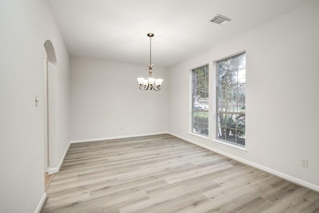 26122 Salt Creek Ln, Katy, TX 77494 - unfurnished room featuring light wood-type flooring, baseboards, arched walkways, and a chandelier