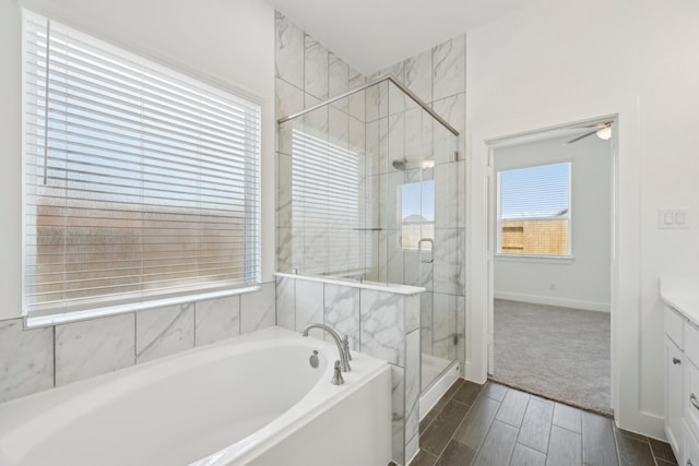 19265 Hazel Firs Ct, Magnolia, TX 77355 - full bathroom with a bath, a shower stall, vanity, wood tiled floors, and ceiling fan