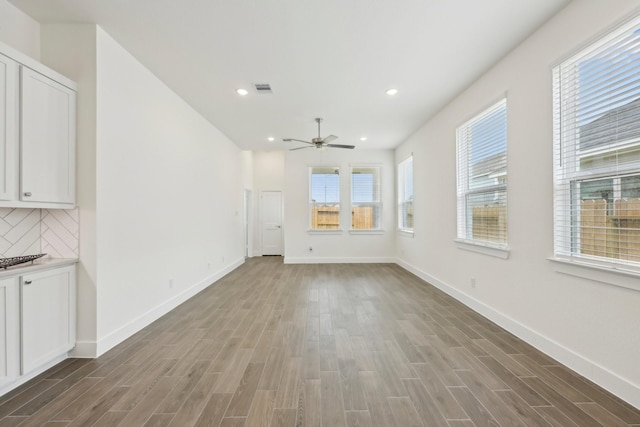 19265 Hazel Firs Ct, Magnolia, TX 77355 - unfurnished living room with wood finished floors, a ceiling fan, and recessed lighting