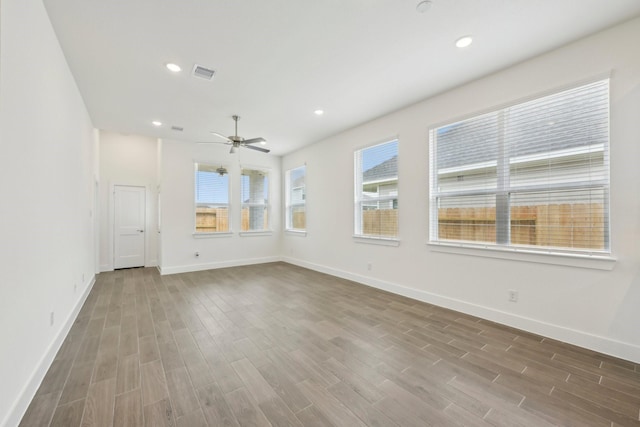 19265 Hazel Firs Ct, Magnolia, TX 77355 - unfurnished room with healthy amount of natural light, wood finished floors, ceiling fan, and recessed lighting