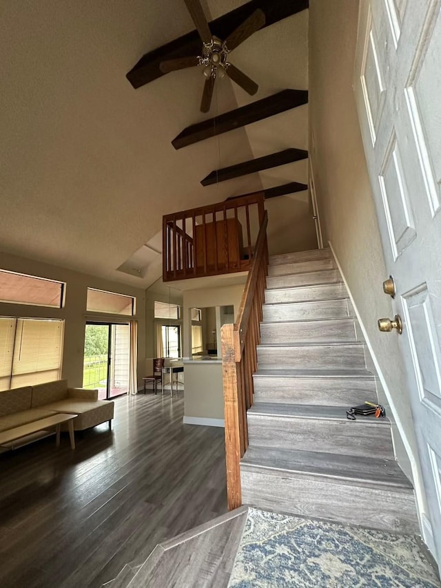 8443 Sands Point Dr, Houston, TX 77036 - staircase featuring a ceiling fan, wood finished floors, a towering ceiling, and baseboards