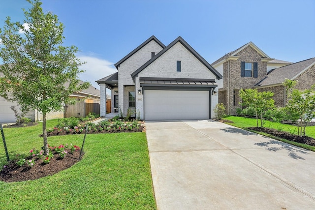 21517 Witham Promenade Ln, Magnolia, TX 77355 - view of front of home featuring driveway, an attached garage, and brick siding