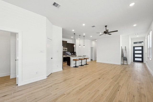 21517 Witham Promenade Ln, Magnolia, TX 77355 - unfurnished living room featuring light wood-style floors, recessed lighting, baseboards, and a ceiling fan