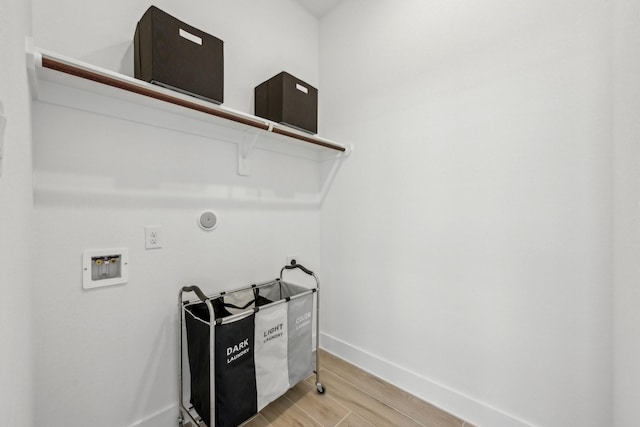 21517 Witham Promenade Ln, Magnolia, TX 77355 - laundry room with baseboards, light wood-style flooring, and hookup for a washing machine