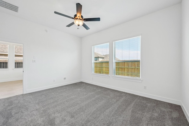 21517 Witham Promenade Ln, Magnolia, TX 77355 - spare room with dark colored carpet, a ceiling fan, and baseboards