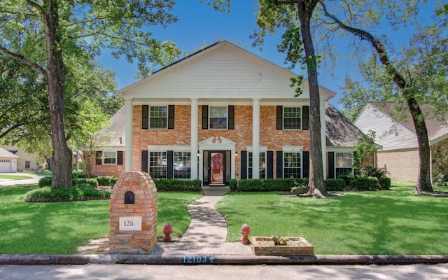 12103 Moorcreek Dr, Houston, TX 77070 - greek revival inspired property featuring a front lawn and brick siding