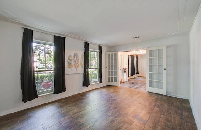 12103 Moorcreek Dr, Houston, TX 77070 - unfurnished room featuring french doors, wood finished floors, a chandelier, and baseboards