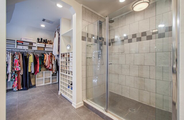 12103 Moorcreek Dr, Houston, TX 77070 - bathroom with tile patterned floors, a stall shower, a walk in closet, and recessed lighting
