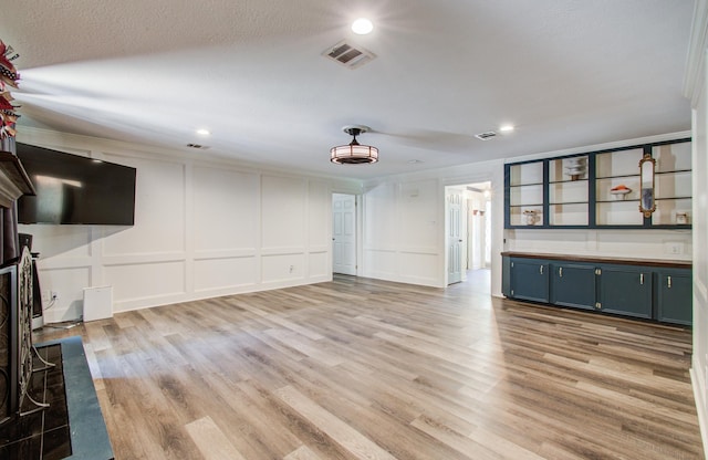 12103 Moorcreek Dr, Houston, TX 77070 - unfurnished living room with a decorative wall, recessed lighting, and light wood-style floors